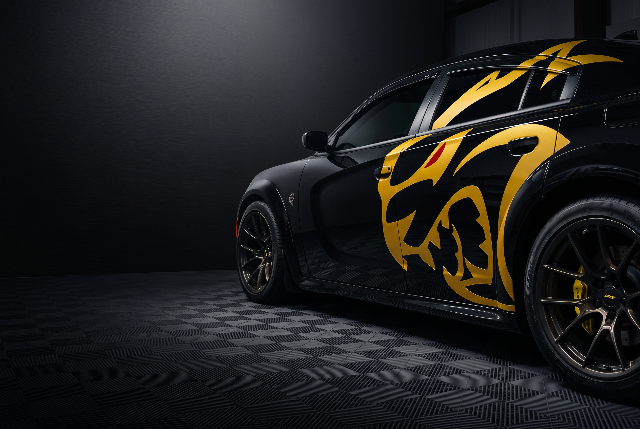 Black performance car with a gold Scat Pack decal