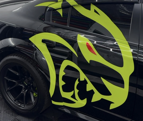 Neon green Scat Pack graphic on a black car