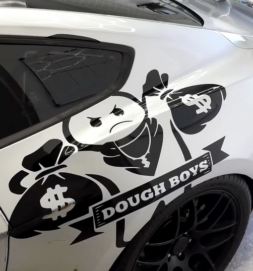 Black Dough Boys graphic on a white car